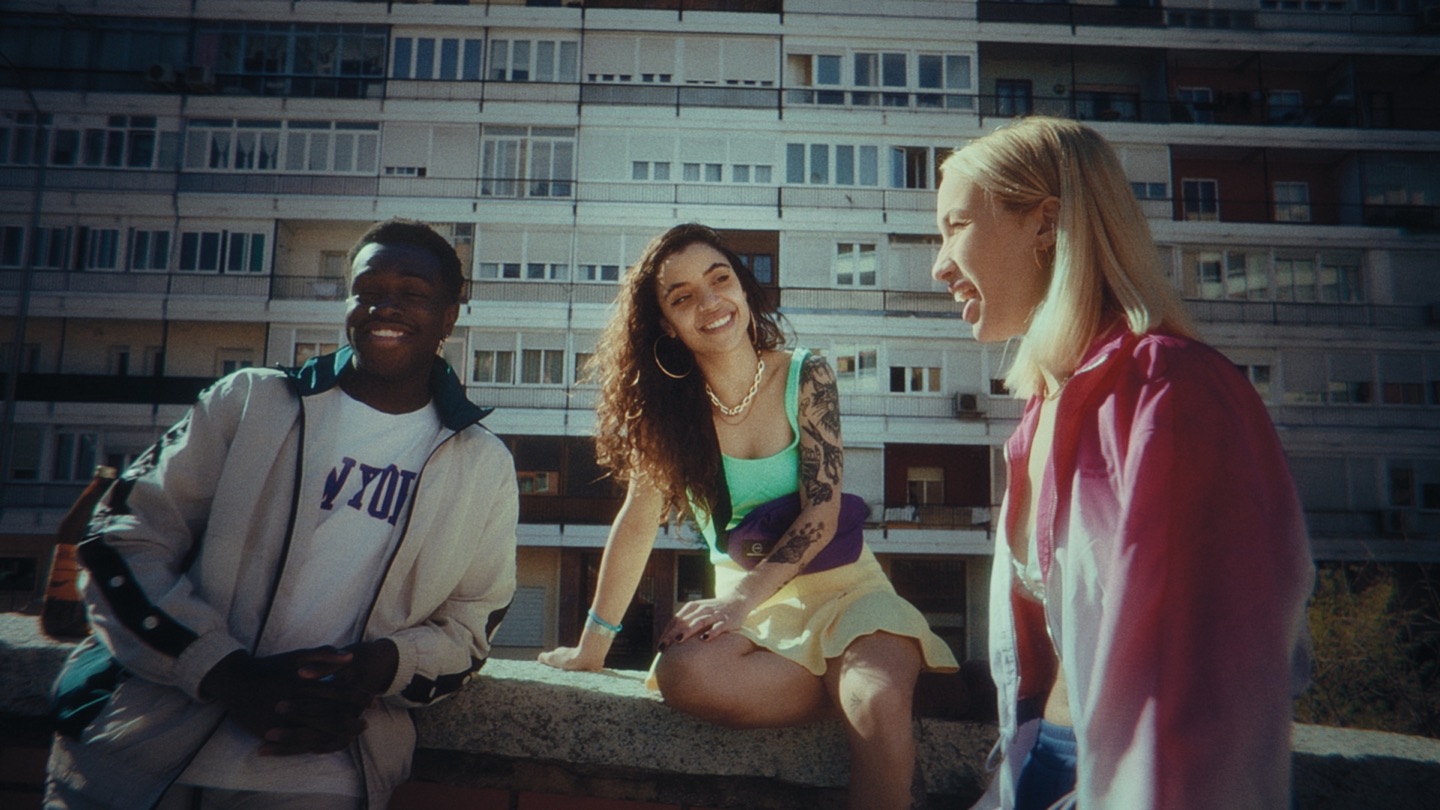 Three friends talking in front of an apartment building